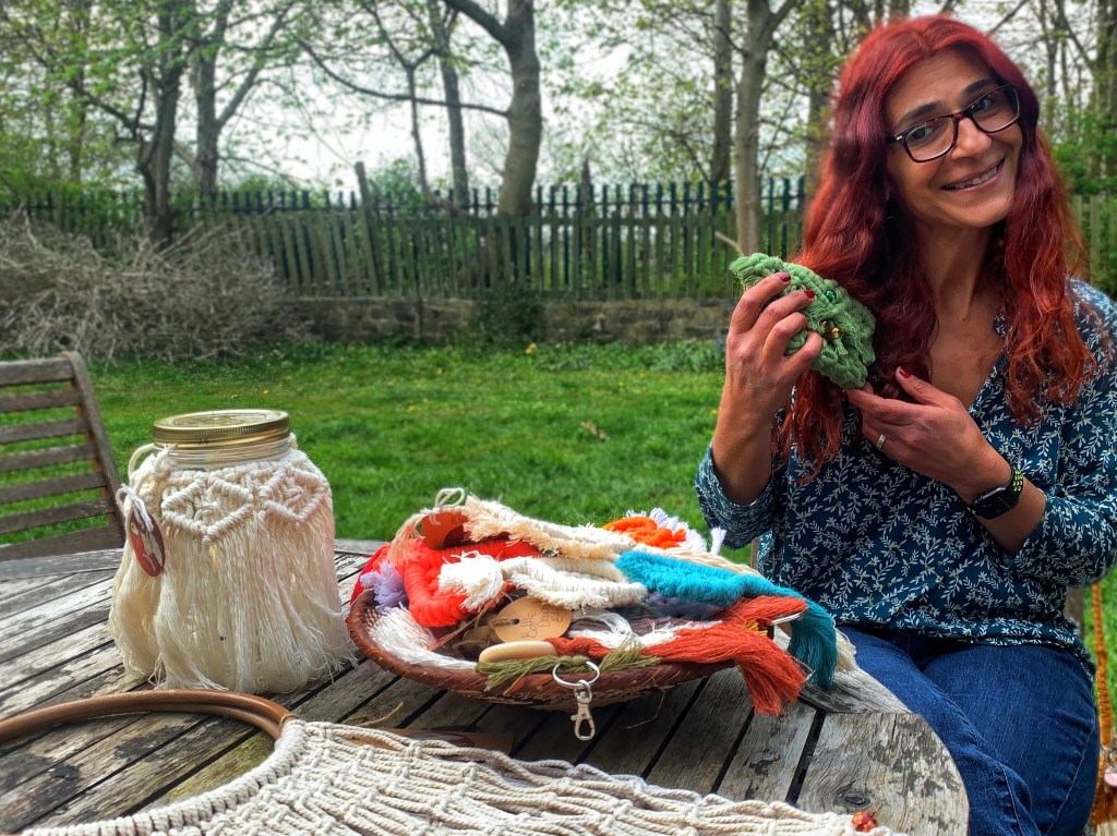 Galit holding some of her macrame products