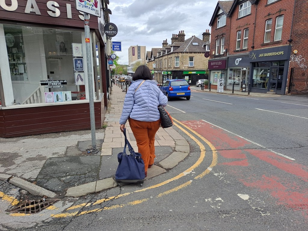 a women walking down the street with shopping bags