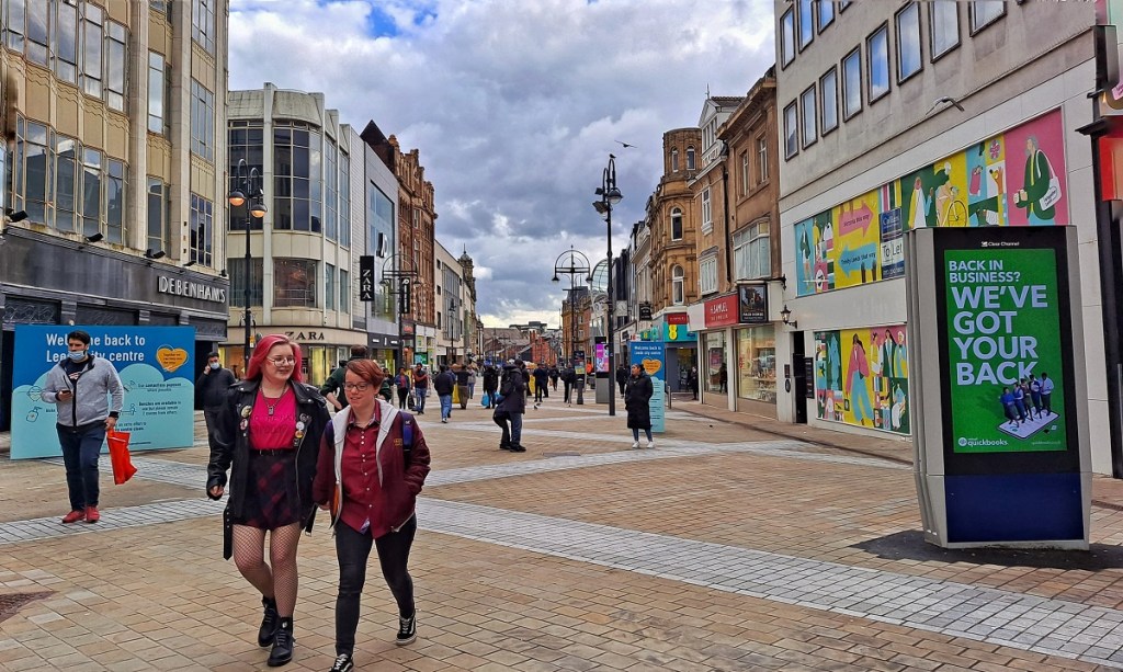 high street with couple and people wearing masks