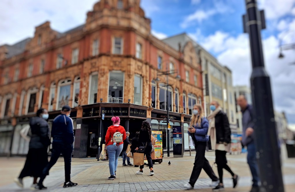 People walk around the now empty Debenhams