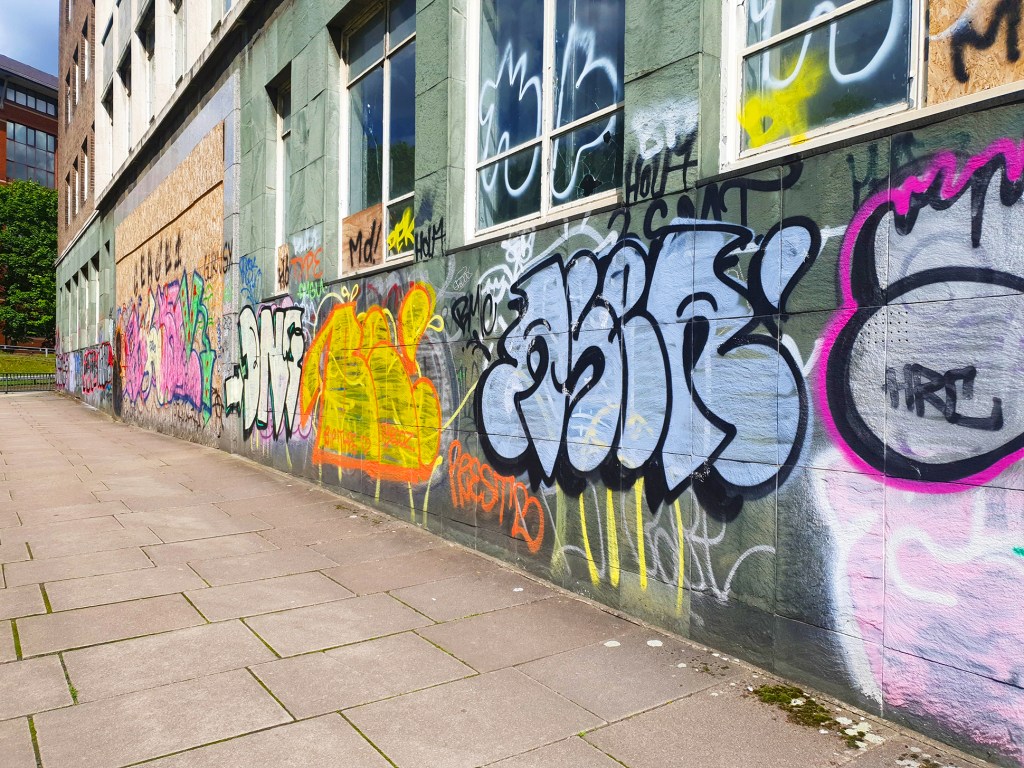 A wall full of graffiti tags