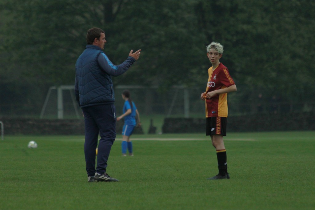 Val (right) talks to her coach Stephen (right