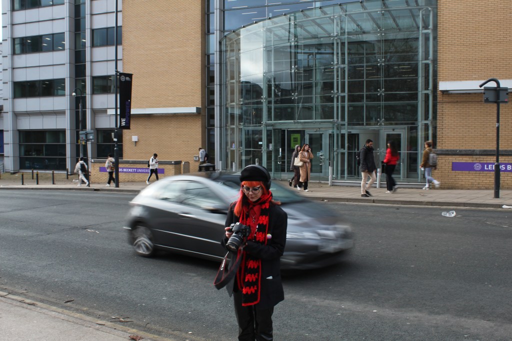Sapphire stood on side of the road as a car drives past