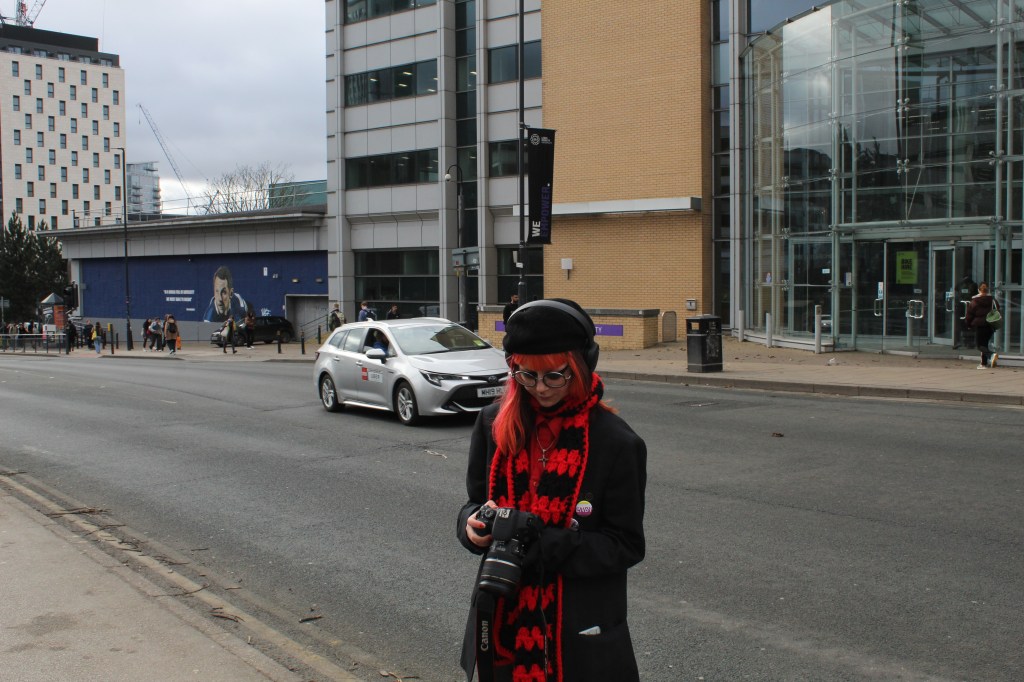 Sapphire stood on side of the road as a car drives past