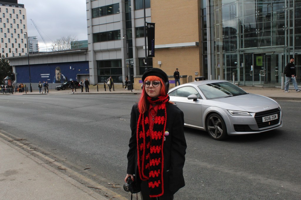 Sapphire stood on side of the road as a car drives past