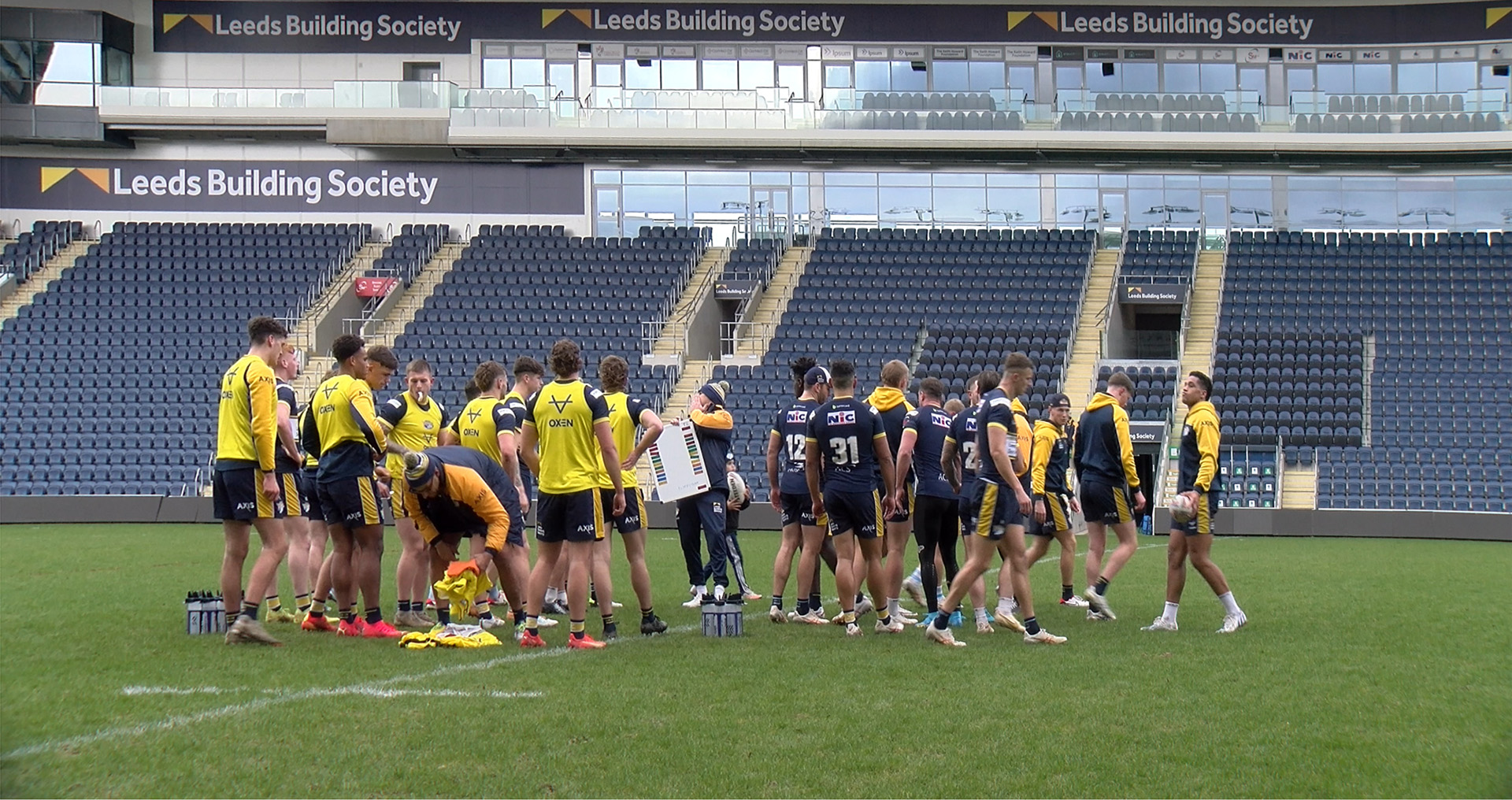 Leeds Rhinos first team in a group as they prepare for a training session on the field at Headingley Stadium.