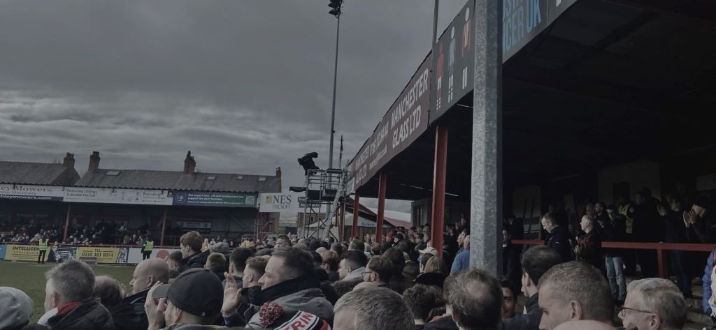 Altrincham fans watch on for the final ten minutes as their side looks to hold on to a 1-0 lead.