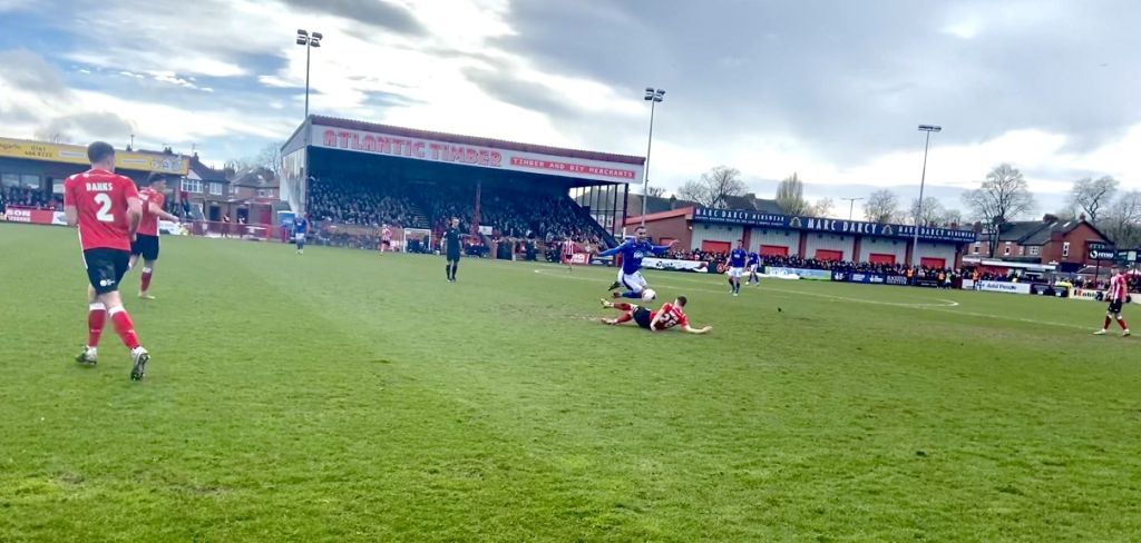 A crunching slide tackle from Alty's number 26 as he clatters into the opponent.