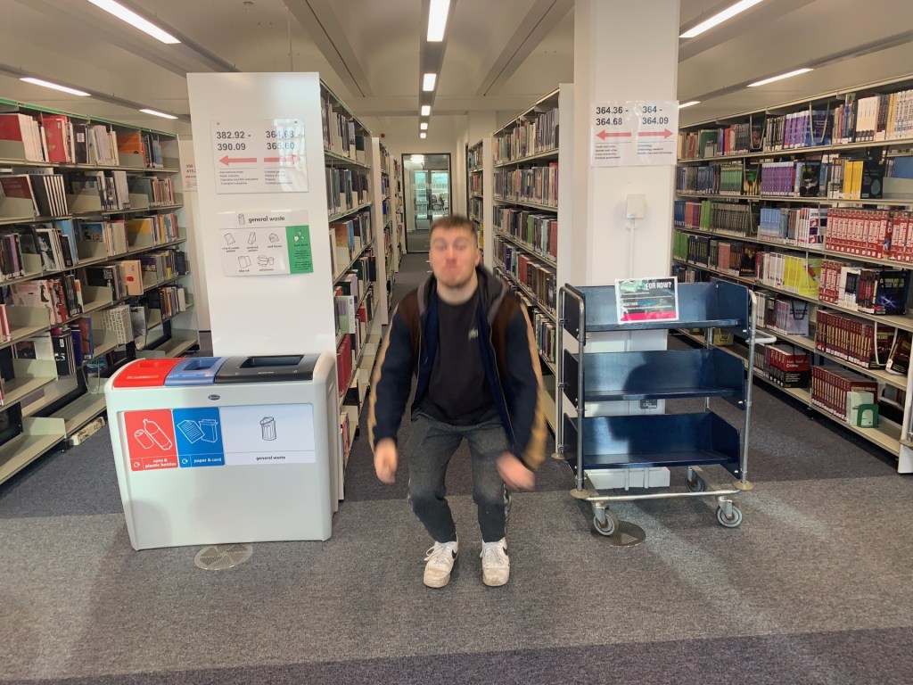 Photo of student about to jump using the burst mode on iPhone in a university library. 