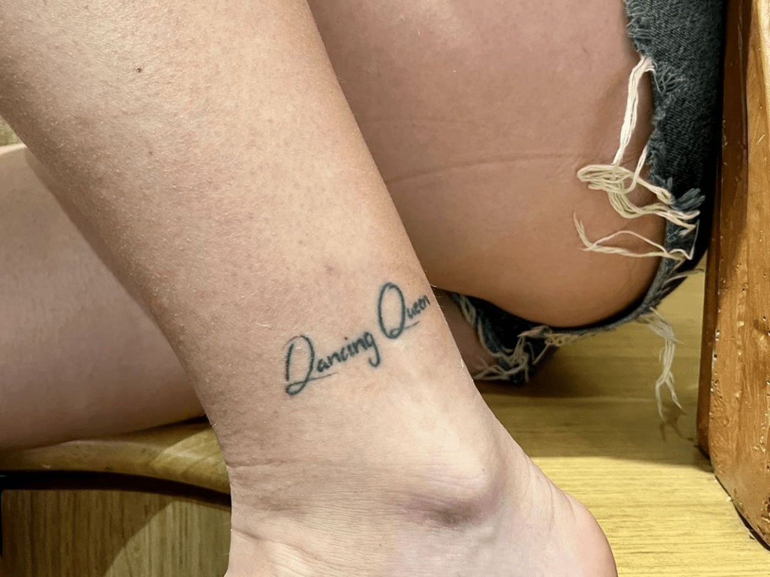 Aisling Gethins Tattoo on her left ankle saying 'dancing queen'