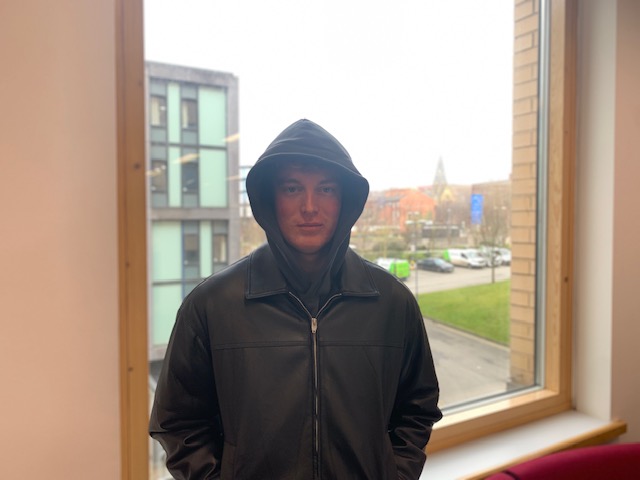 Photo of student with background of Leeds Beckett University with middle F setting. 