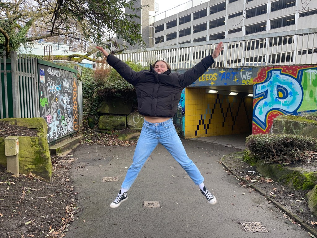 Lucy jumping to capture movement whilst using a fast shutter speed, ensuring the picture is clear and in focus