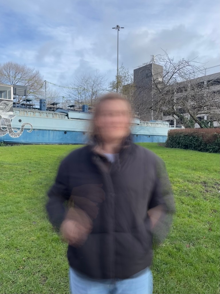 Lucy moving around to capture movement whilst using a slow shutter speed, making her blurry and the background in focus