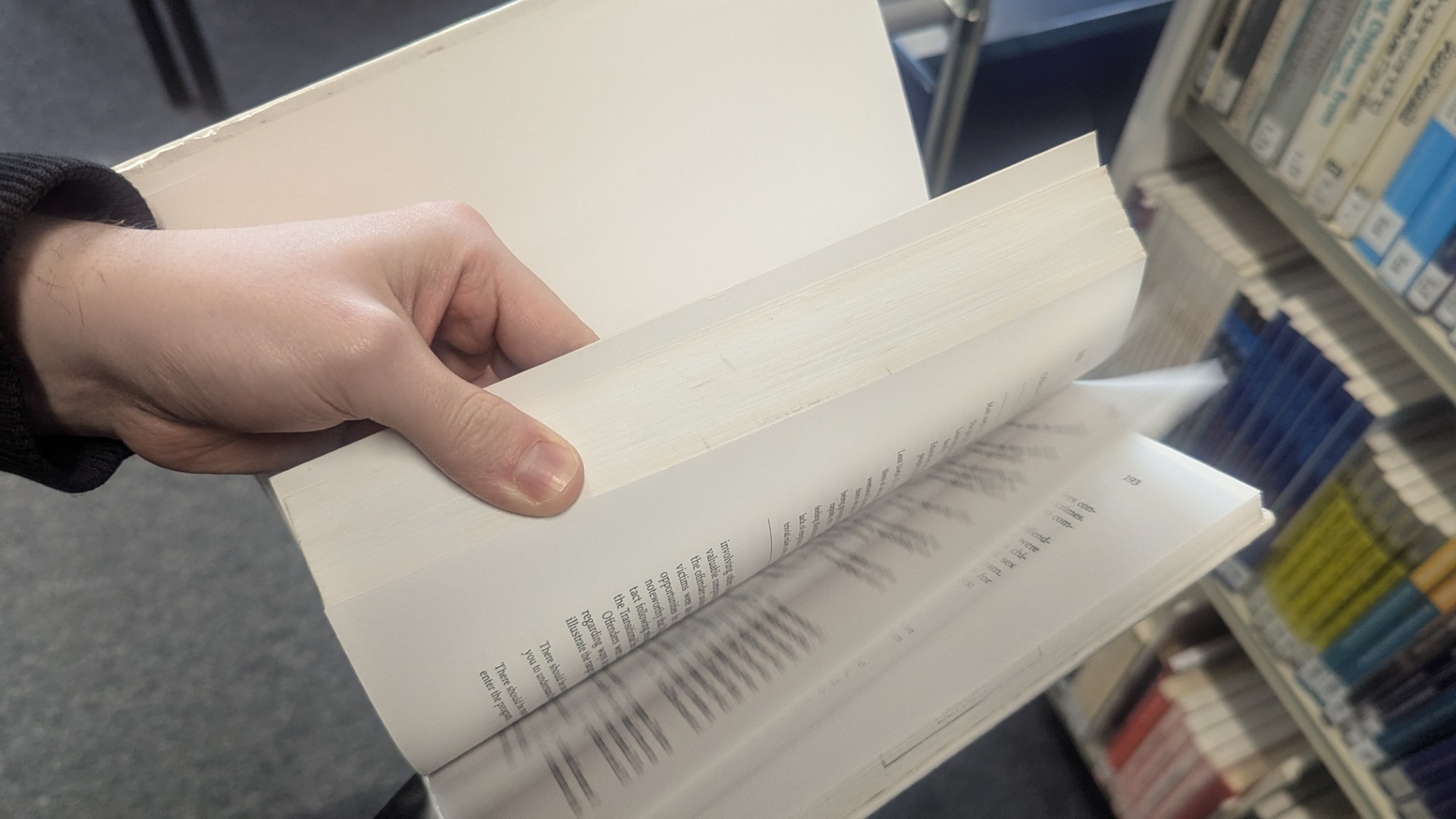 A person flicking through the pages of a book.