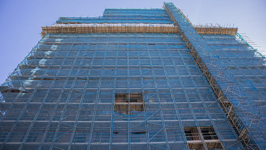 Building under blue scaffolding.  