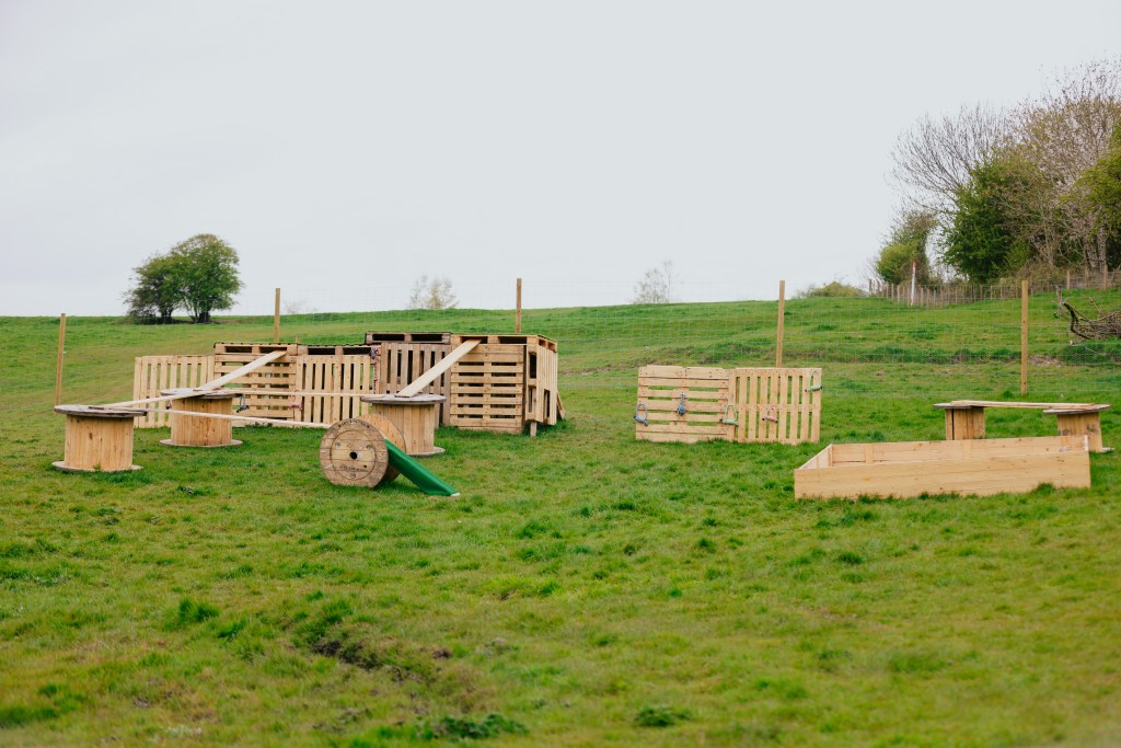 A wooden obstacle course in a field