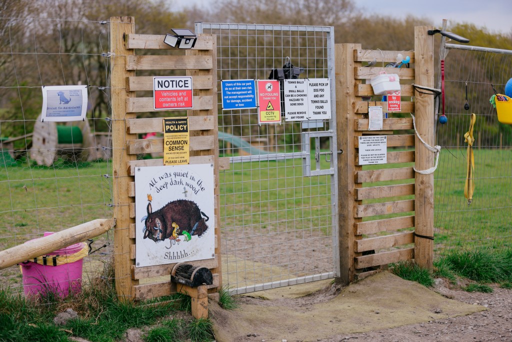 A gate with lots of signs
