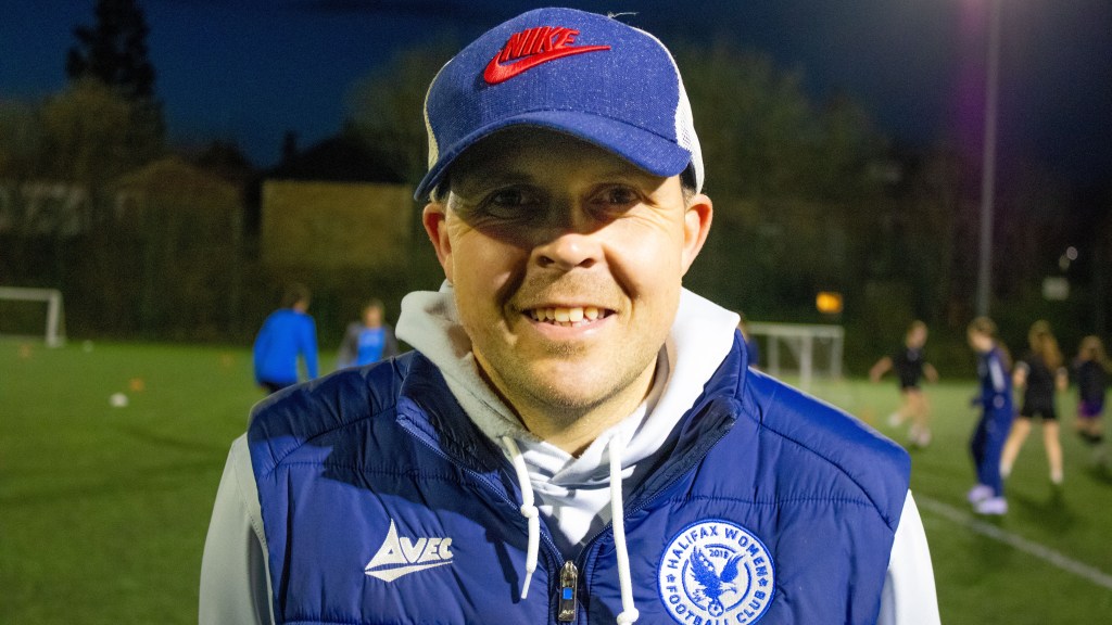 Rob Mitchell wearing a blue Halifax gilet looking into the camera at night at a training ground